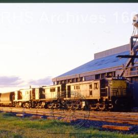 ALUMINIUM HOPPER WAGON WHEAT TRAIN ON SILO SIDING TRAIN IS TRIPLE HEADED BY 48-CLASS ENGINES, UNKNOWN LOCATION, NSW, [N.D.]